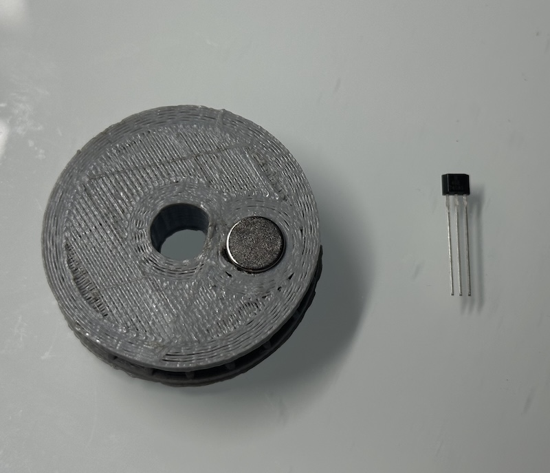 Hall-effect sensor mounted near the motor and drive wheel